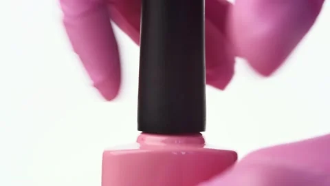 A hand opens a bottle of pink nail polish Stock Footage 196223186