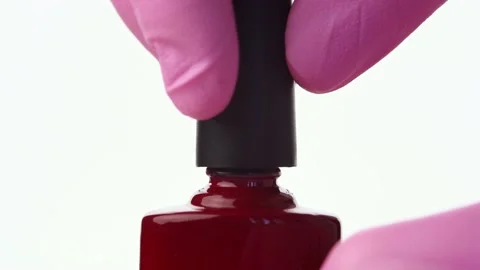 A hand opens a bottle of red nail polish Stock Footage 196223359