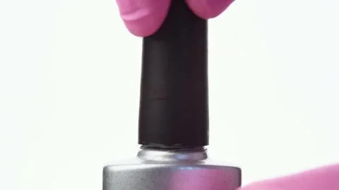 A hand opens a bottle of silver nail polish Stock Footage 196223281
