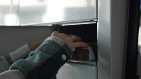 The hand opens the box and takes his package. Receiving an order through an Stock Footage 297461368