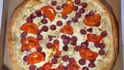 A hand opens a brown pizza box. Pizza in a box close-up. Stock Footage 221894810