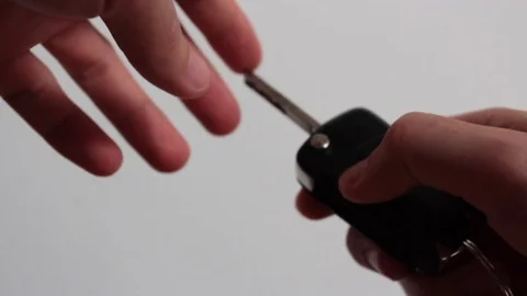 Hand opens a car key Stock Footage