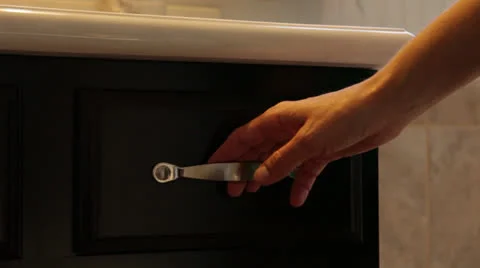 Hand opens &amp; closes bathroom drawer, close-up 3 Stock Footage 25912724