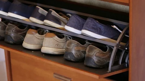 The hand opens closet with men's shoes. Stock Footage