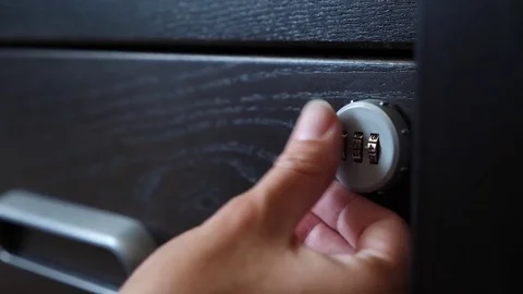 The hand opens the coded lock of the safe. 4k. Slow motion. Stock Footage 78025766