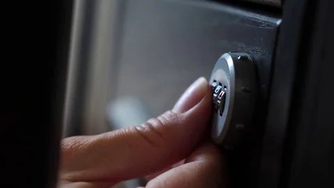 The hand opens the coded lock of the safe. 4k. Slow motion. Stock Footage 78072488