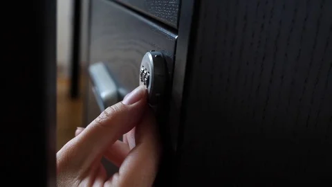 The hand opens the coded lock of the safe. 4k. Slow motion. Stock Footage 78073782