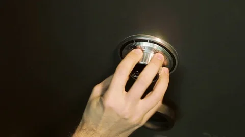 A Hand Opens a Combination Lock on a Steel Vault Stock Footage 70397106