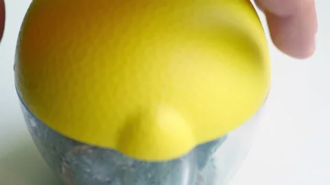 The hand opens a container with a spoiled moldy lemon. Stock-Footage 158698401