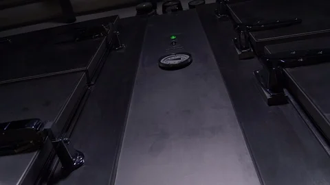 A HAND OPENS DOOR ON A MORGUE COLD STORAGE UNIT.  4K 10 BIT ECU SLIDER SHOT. Stock-Footage 100201922
