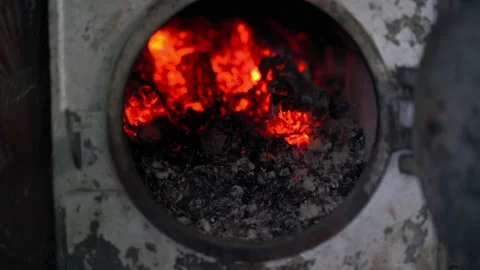The hand opens the door with smoldering red coals close-up Stock Footage 219367266