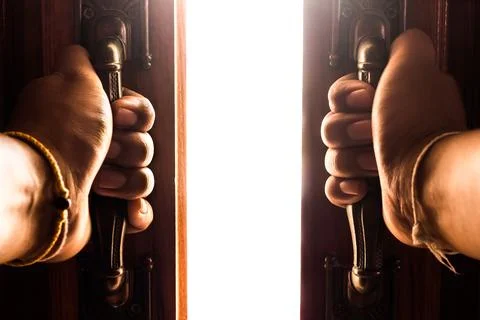 Hand opens empty room door Stock Photos