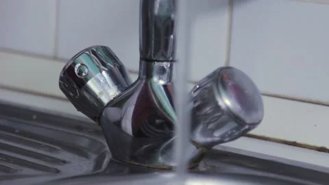 Hand opens the faucet with water in the kitchen Stock Footage 202117239