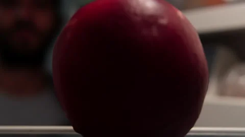 Hand opens a fridge and grabs a peach at night, close-up Stock Footage 250821699