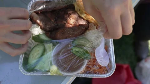 Hand opens to go vietnamese meal close up Stock Footage 156879010