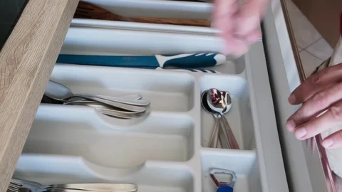 Hand opens kitchen drawer, selects scissors from organized cutlery compartment Stock Footage 315770854