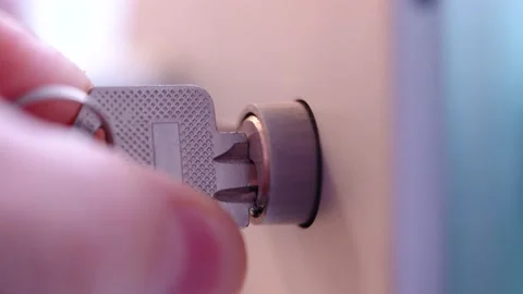 Hand opens lock on door with key, twists in both directions, macro shooting Stock Footage 233539646