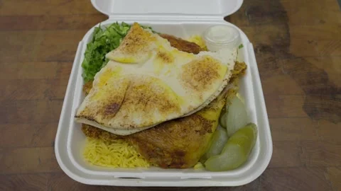 Hand opens middle easter Iraqi chicken dish Stock Footage 306886248