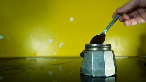 Hand opens a mocha coffee maker to get coffee in powder to make coffee for Video stock 98235399