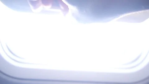 The Hand Opens The Plane Window. Airplane wing, Clouds And Sky Visible Throu Stock Footage 144881637