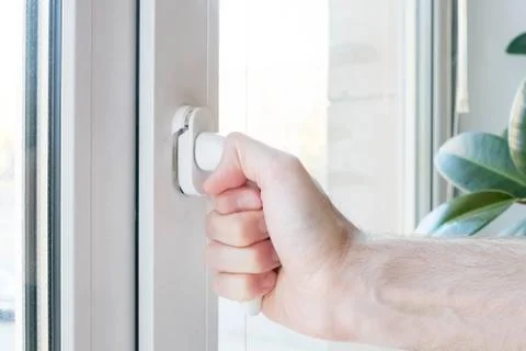 The hand opens a plastic window, the mechanism breaks Stock Photos