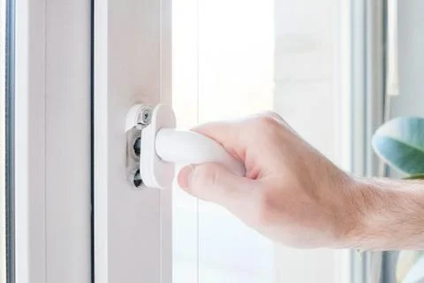 The hand opens a plastic window, the mechanism breaks Stock Photos