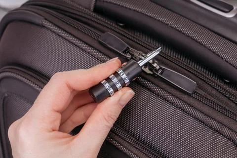 Hand opens suitcase combination lock Stock-Fotos