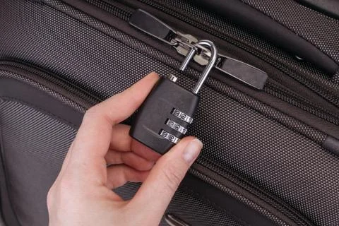 Hand opens suitcase combination lock Stock Photos