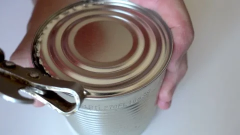 Hand opens tin can with corn in time lapse Stock Footage 241747866