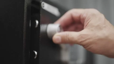 Hand opens a touchpad digital safe with a keypad sitting on a black surface.  Stock Footage 294972052