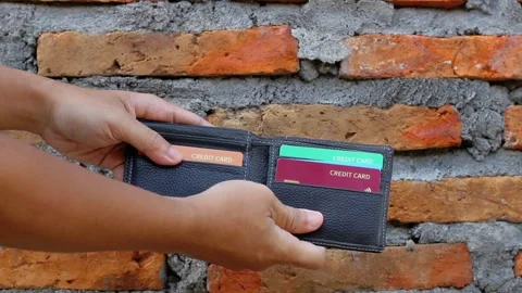 Hand opens wallet containing several colorful credit cards Video stock 323035964