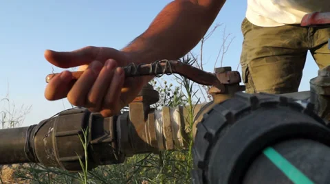 Hand opens water valve Stock Footage 35654552