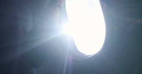 A hand opens a window in an airplane, porthole Stock Footage 80250350