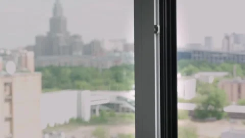 A hand opens a window in an apartment or house for ventilation Stockbeeldmateriaal 252660010