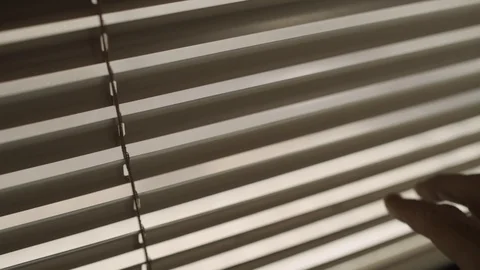 Hand opens window blinds to peek and spy through them Vidéo 109163901