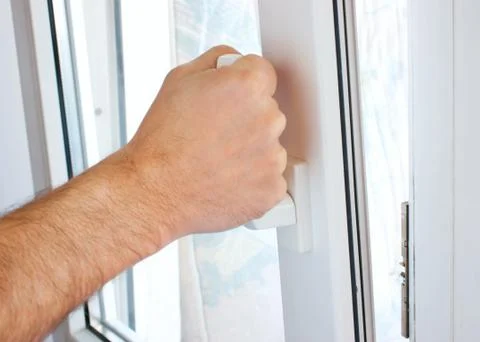 Hand opens a window Stock Photos