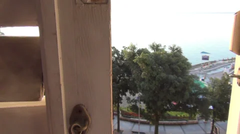 The hand opens the window in which the early morning on the sea Stock Footage 39705066