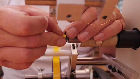 Hand operate coil winding machine reeling insulating tape on transformer Video stock 139743594