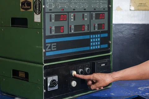 Hand operating and pressing the control panel buttons of CEMB ZE50 Stock Photos