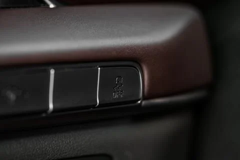 Hand operating ESP (electronic stability program) control close up view. Inte Stock Photos