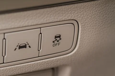 Hand operating ESP (electronic stability program) control close up view. Inte Stock Photos