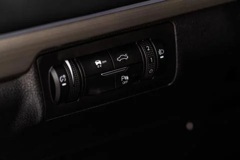 Hand operating ESP (electronic stability program) control close up view. Inte Stock Photos