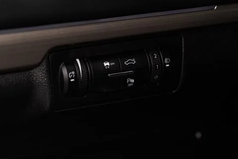 Hand operating ESP (electronic stability program) control close up view. Inte Stock Photos