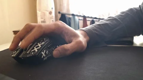 A hand operating a gaming mouse on a mousepad Stock Footage 329748175