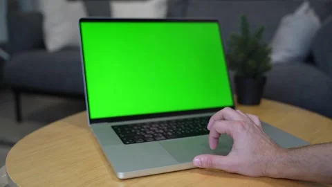 Hand Operating Green Screen Laptop On Wooden Table Stock Footage 337618394