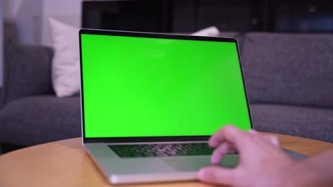 Hand Operating Green Screen Laptop On Wooden Table Stock Footage 338128332