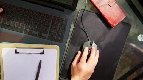 Hand operating a laptop mouse. Top-down view of working on a laptop. 動画素材 331761066