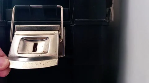 Hand Operating Metal Latch on Rugged Black Storage Container Stock Footage 324702613