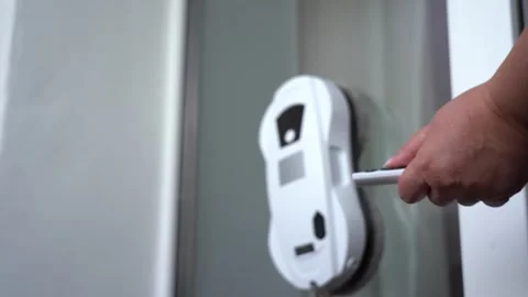A Hand Operating a Modern Smart Device on a Glass Door, Enhancing Home Vídeos de archivo 333514360