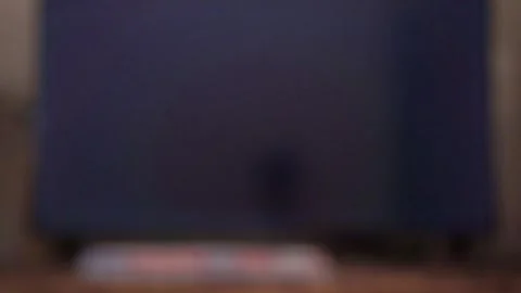 Hand operating television remote control to switch on tv, navigating smart TV Stock Footage 342636533